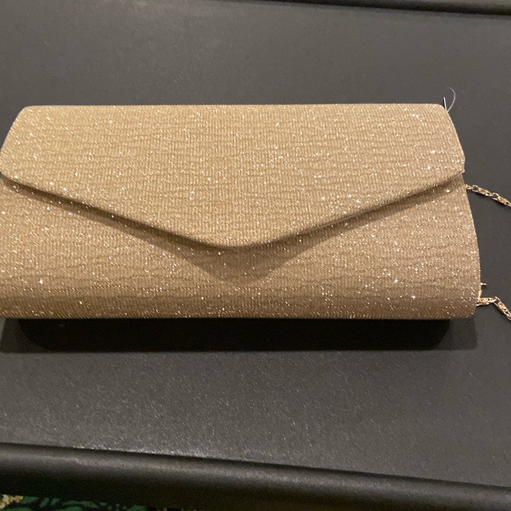 Pretty, sparkly, roomy clutch w/chain . Gold clutch can be used for dressy event